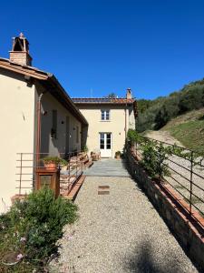 a walkway leading to a building with a house at IL COLLE rooms in Lucca
