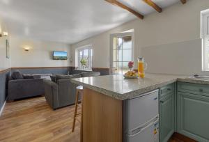 an open kitchen and living room with a couch at Landscove Chalet 19 in Brixham +11 photos