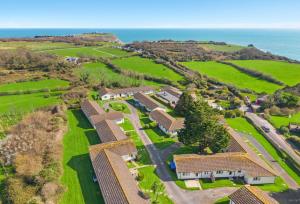 an aerial view of a house with the ocean in the background at Landscove Chalet 19 in Brixham