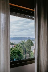 a window view of the ocean from a hotel room at Hotel Temu in Villa Carlos Paz