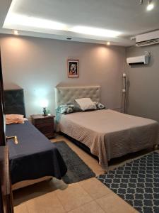 a bedroom with two beds and a lamp on a table at Casademontaña in Belén