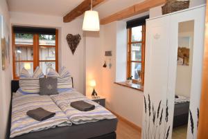 a bedroom with a bed with pillows on it at Dannauer Reetkate - Wiesenblick in Oldenburg in Holstein