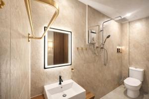 a bathroom with a toilet and a sink and a shower at Bugis Social-Newly Renovated in Singapore +102 photos
