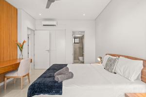 a bedroom with a bed with a desk and a chair at Penthouse Kyo - Private Rooftop & Jacuzzi in Grand-Baie