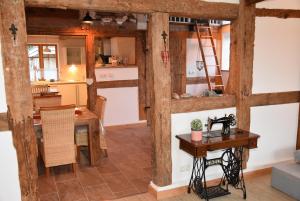 a kitchen and dining room with wooden beams at Dannauer Reetkate - Wiesenblick in Oldenburg in Holstein