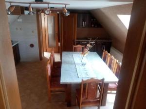 a dining room with a table and chairs at Lastovička in Ihráč