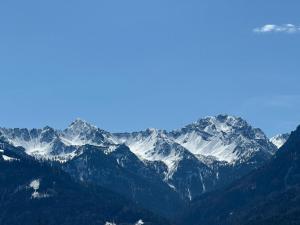 a view of a mountain range with snow covered mountains at Garage Loft in Satteins