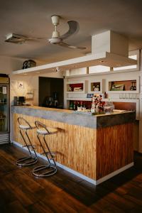 a kitchen with a bar with two stools at Hotel Temu in Villa Carlos Paz