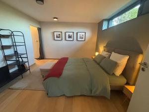a bedroom with a large bed and a window at La Rosière en Gaume in Musson