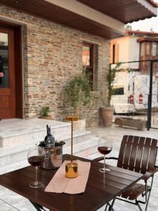 a wooden table with two glasses of wine on a patio at The Pilgrim Ephesus Hotel in Selçuk +36 photos