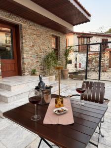 a table with two glasses of wine on a patio at The Pilgrim Ephesus Hotel in Selçuk