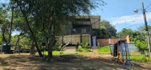 a house with a playground in front of a tree at Cabaña con piscina y vista al lago in San Bernardino +8 photos