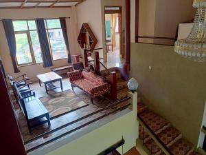 an aerial view of a living room with a couch and chairs at Villa KenDedes Garden in Batu