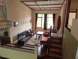 a living room with a couch and a table at Villa KenDedes Garden in Batu