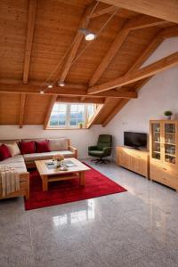 a living room with a couch and a table at Helle Ferienwohnung im Bayerischen Wald mit Balkon, Garten & viel Platz für 4 in Mauth