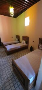 a room with two beds in a room at Esc 6 3 9 in Fez