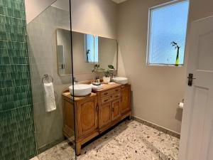 a bathroom with two sinks and a shower at Lagoon View Cottage in Knysna +14 photos