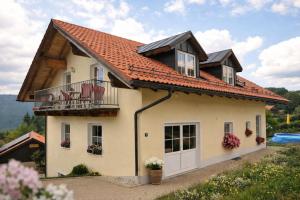 a house with a red roof at Helle Ferienwohnung im Bayerischen Wald mit Balkon, Garten & viel Platz für 4 in Mauth