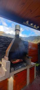 an outdoor oven with a pizza cooking in it at Casademontaña in Belén