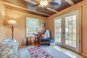 a living room with a ceiling fan and windows at Quaint Mountain Charm! Robbinsville Hideaway in Robbinsville