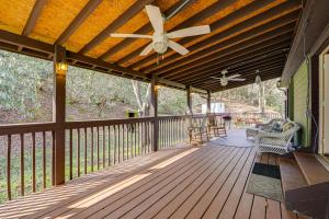 a covered deck with a ceiling fan and a couch at Quaint Mountain Charm! Robbinsville Hideaway in Robbinsville