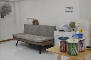 a living room with a couch and a table at alone happy 3 in Ban Khlong Thewa