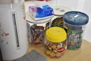 a counter with some food and a jar of food at alone happy 3 in Ban Khlong Thewa +3 photos