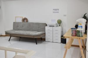 a living room with a couch and a table at alone happy 3 in Ban Khlong Thewa