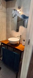 a bathroom with a white sink and a mirror at Nel borgo San Francesco in Montesarchio