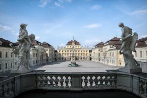 a view of a building with statues on a bridge at enjoyHotel garni Korntal Stuttgart b&b Parkplatz Sprinter Penny eTank Porsche-Museum in Stuttgart