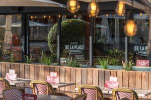 a row of tables and chairs in front of a restaurant at Hotel de l'Océan et restaurant - Coeur de ville in Biarritz +47 photos