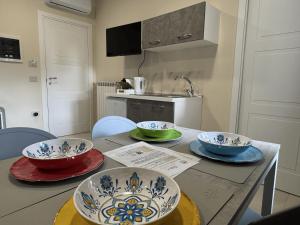 a kitchen with three bowls on a table at Rafinù B&B in Ercolano