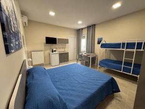 a bedroom with two bunk beds and a kitchen at Rafinù B&B in Ercolano +34 photos