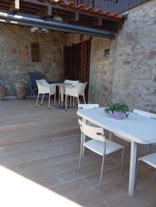 a group of tables and chairs on a patio at CASA DE MADEIRA E PEDRA in Afife