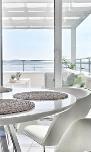 a white dining room with a view of the ocean at Terra & Salt in Bibinje +54 photos