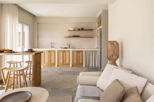 a living room with a couch and a kitchen at Cavo Dio 1 - Beachfront bliss - Cozy Apt Pool Sunset in Káto Dhiminión