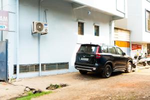 a black suv parked in front of a building at Jageshwari Executive in Kolhapur