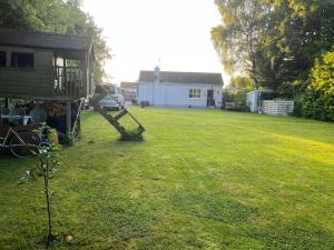 a yard with a house and a playground at Serenity Cottage in Newpark