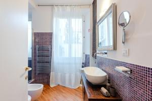 a bathroom with a sink and a shower with a mirror at BM7-Design&Style in Milan +27 photos