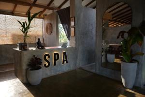 a spa room with potted plants and a sign at Surf's Up LOFT in Weligama