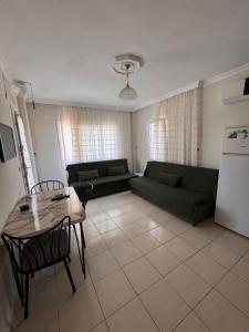 a living room with a couch and a table at Mermaid in Marmaris