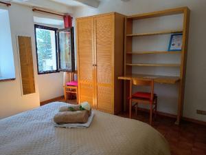 a bedroom with a bed and a desk and shelves at Romantic getaway on Lake Como in Brunate