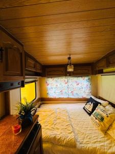 a large bed in the middle of a room at Dębowy zakątek camping in Pobierowo