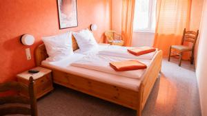 a bedroom with a large bed with white sheets and pillows at Hotel Eifeltor in Mechernich
