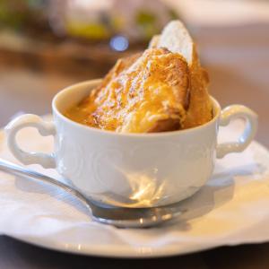 a piece of cake in a white cup on a plate at Hotel Eifeltor in Mechernich +10 photos