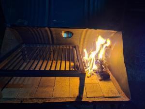 a fire is burning in front of a bench at Su Escapada Perfecta in Ruiz de Montoya