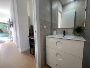 a bathroom with a sink and a mirror at Cozy apartment in Leganés in Leganés