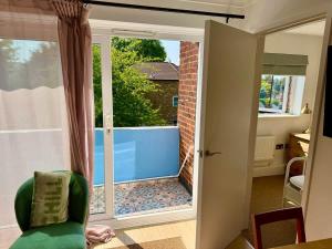 a room with a sliding glass door to a pool at Modern 2-Bed Apartment with Off-Street Parking in Chiswick in London