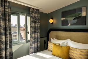 a bedroom with a bed and a window at Hôtel le 6 Tiquetonne in Paris