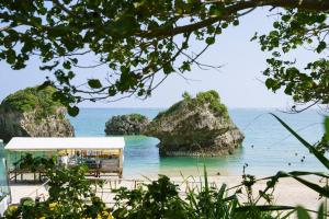 a view of a beach with rocks in the water at Ocean view cabin in Nanjo